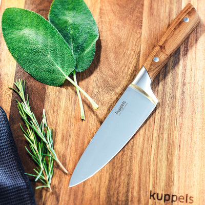 Kuppels AVID Kochmesser, scharfes Küchenmesser mit Edelstahlklinge und Holzgriff, auf Schneidebrett liegend